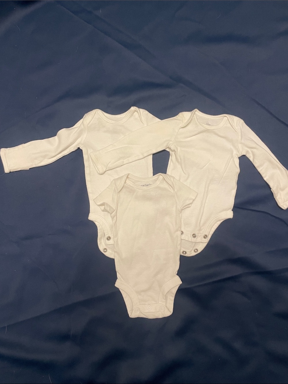 Lot of white newborn onsies